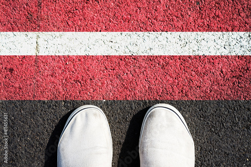 Sneakers and the Latvia flag. View from above.