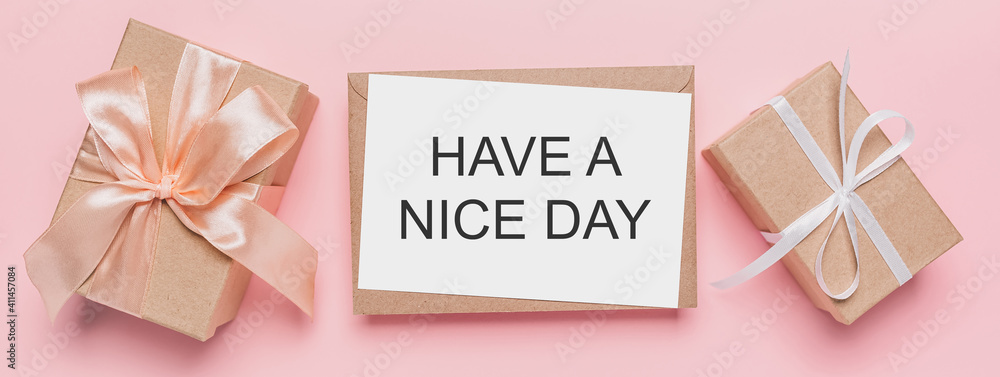 Gifts with note letter on isolated pink background, love and valentine concept with text HAVE A NICE DAY Gifts with note letter on isolated pink background, love and valentine concept with text HAVE A NICE DAY