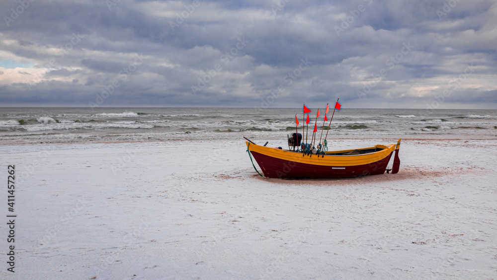 Fishing boat on a snowy beach in winter, Baltic sea Fishing boat on a snowy beach in winter, Baltic sea