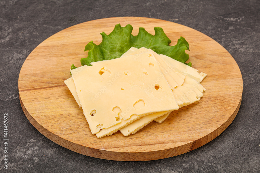 Sliced yellow cheese over board