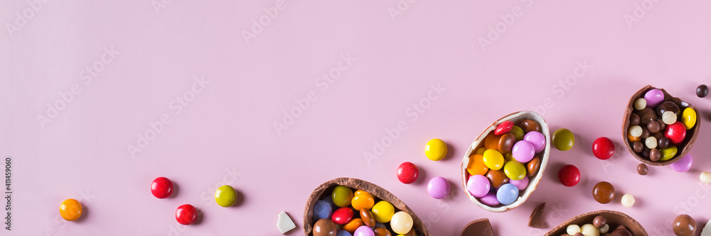 Festive Easter background with chocolate eggs and sweets Festive Easter background with chocolate eggs and sweets