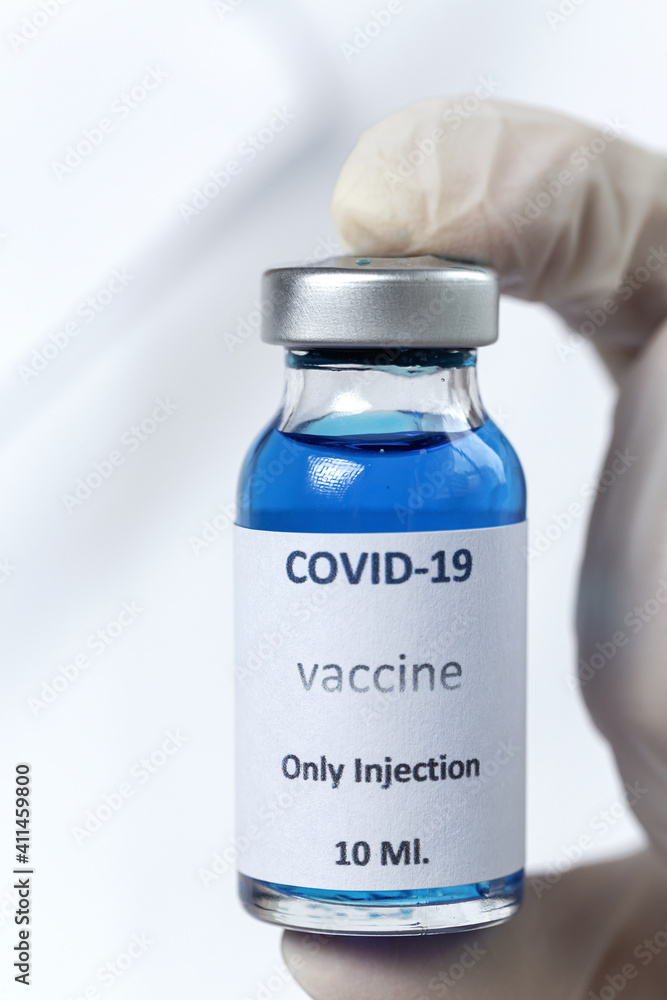 COVID-19 vaccine in researcher hands, unrecognizable female doctor holds syringe
