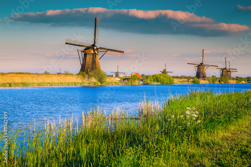 Old wooden windmills on the waterfront at sunset, Kinderdijk, Netherlands © janoka82