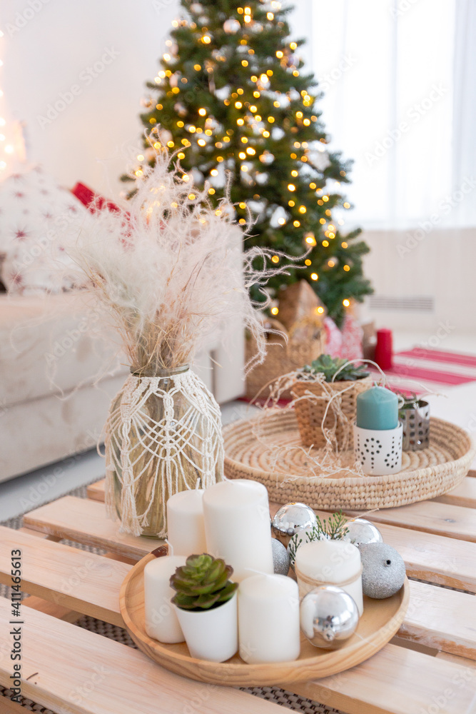 large very bright spacious stylish open plan Bali style apartment with hanging bed and panoramic windows. white floor and walls, simple wooden furniture. decorated with a christmas tree large very bright spacious stylish open plan Bali style apartment with hanging bed and panoramic windows. white floor and walls, simple wooden furniture. decorated with a christmas tree