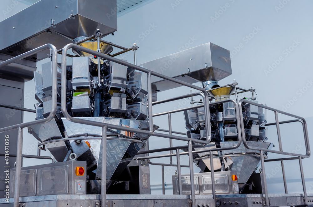 Fototapeta premium Vertical multi-head weigher packaging machine snacks and chips in a factory