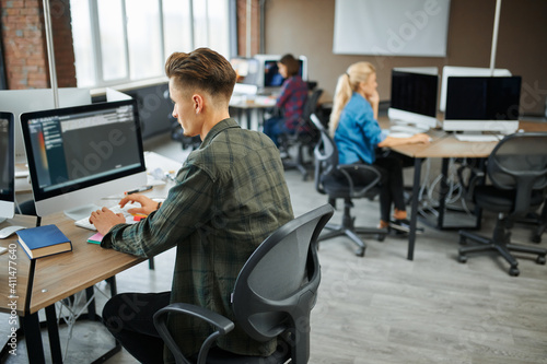 Wallpaper Mural IT specialists group works at the tables in office Torontodigital.ca
