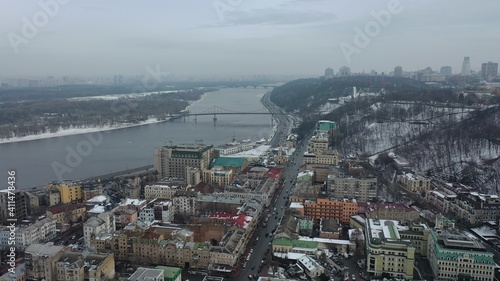 Europe, Kiev, Ukraine - February 2021: aerial view of the Podil area, St. Andrew's Church, Kontraktova Square and Kiev. Old residential buildings overlooking the city.