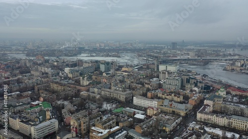 Europe, Kiev, Ukraine - February 2021: aerial view of the Podil area, St. Andrew's Church, Kontraktova Square and Kiev. Old residential buildings overlooking the city. © ShapikMedia