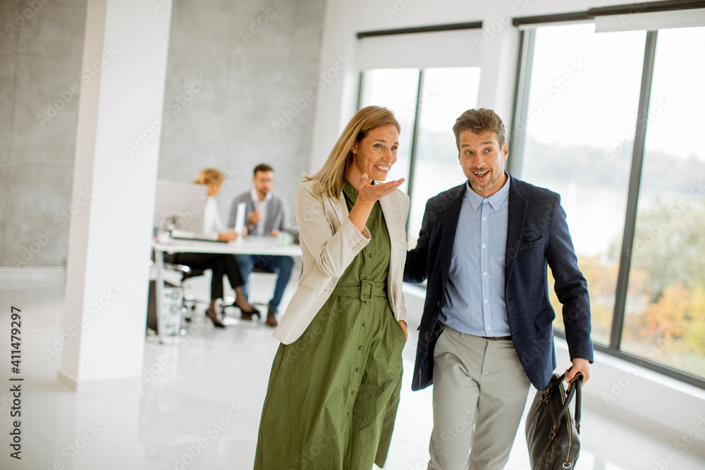 Young business couple walking together at office space Young business couple walking together at office space