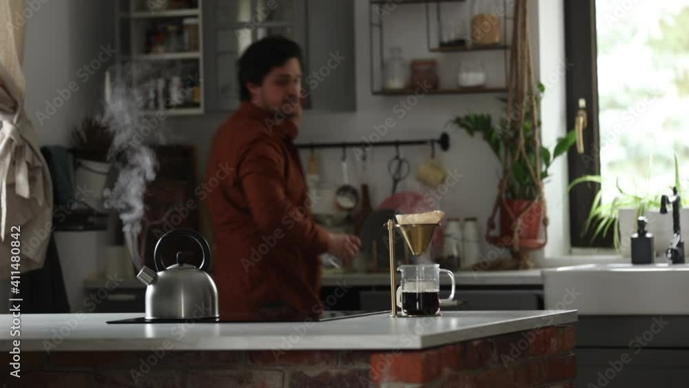 guy makes coffee in the kitchen in the morning guy makes coffee in the kitchen in the morning