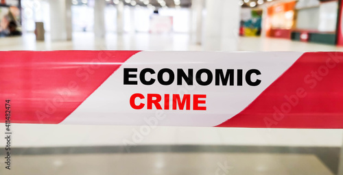 ECONOMIC CRIME - financial text on red ribbon with restriction