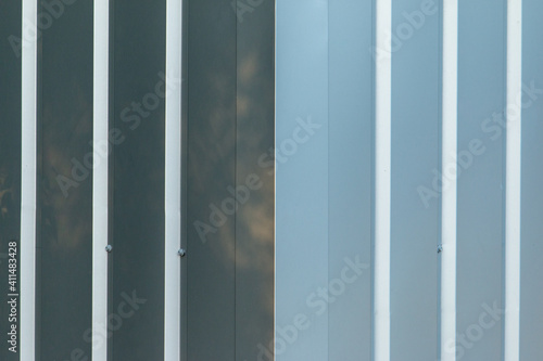 a centered corner of a shiny metal panel wall of a building