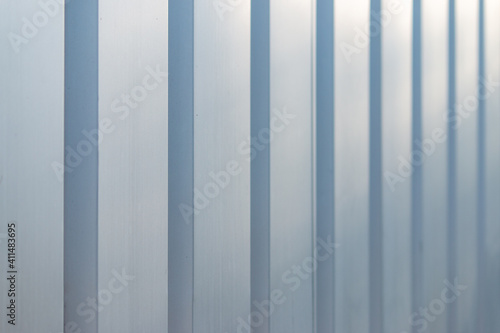 Gray-blue metal panel striped wall receding into the distance