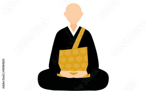 袈裟と法衣に身を包んで坐禅を組む僧侶