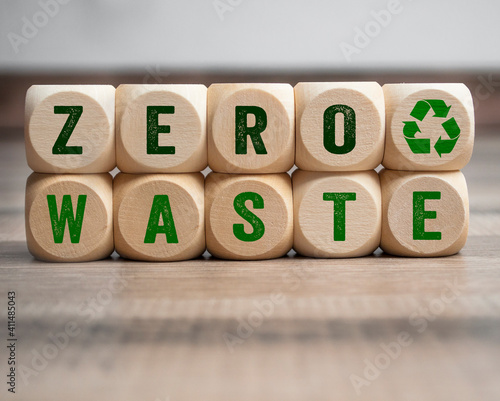 Cubes, dice or blocks with zero waste and recycling logo on wooden background photo