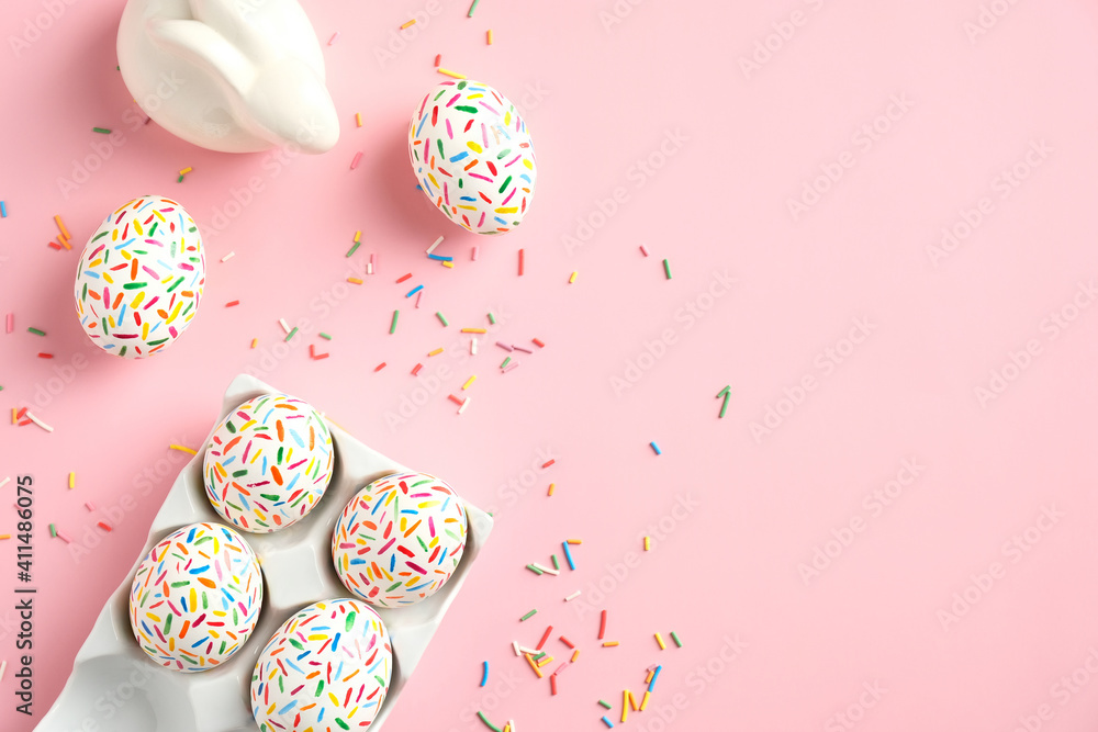 Creative layout with colorful Easter eggs and bunny on pink background. Happy Easter banner mockup. Minimal style. Flat lay, top view.