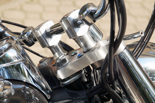 Modern motorcycle handlebar with accessories. Chrome-plated surfaces.