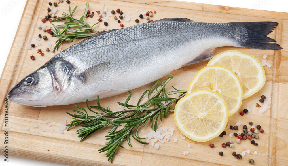Fresh uncooked pike perch with lemon, rosemary and spice on wooden board on white background Fresh uncooked pike perch with lemon, rosemary and spice on wooden board on white background