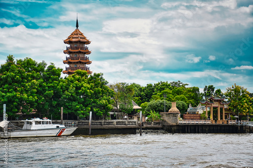Buildings with traditional thai architecture on the bank of the Chao Phraya river