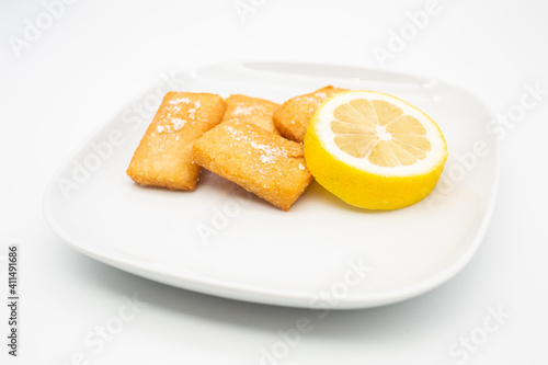 Traditional Sicilian panelle on dish. Typical Sicilian street food. White Background. photo