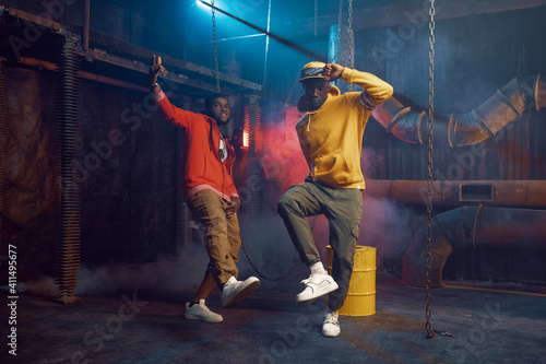 Two stylish rappers, breakdancing in studio photo
