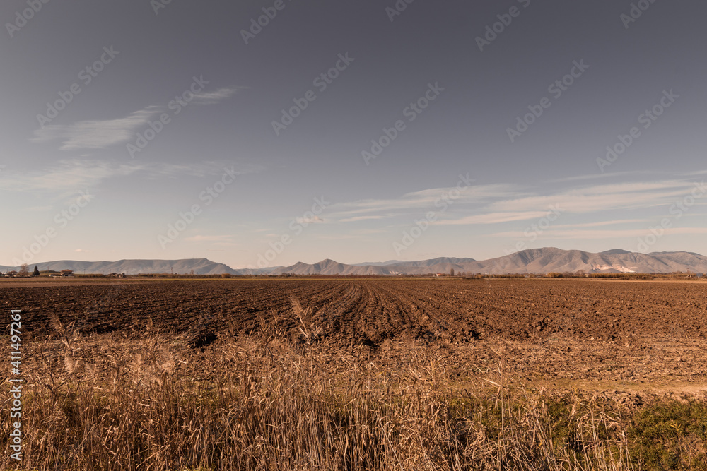 plowed field in winter. field laying dormant during the winter. rural area fields.