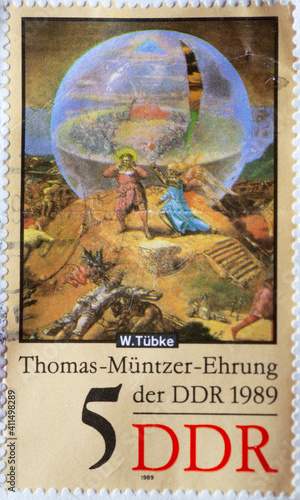 GERMANY, DDR - CIRCA 1989 : a postage stamp from Germany, GDR showing a painting for the birthday of the theologian, reformer, printer and revolutionary Thomas Müntzer. Annunciation by angels photo
