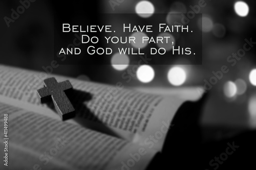 Christian inspirational quote - Believe. Have faith. Do your part, and God will do His. With wooden holy cross crucifix of Jesus Christ on open bible book page in black and white background. 
