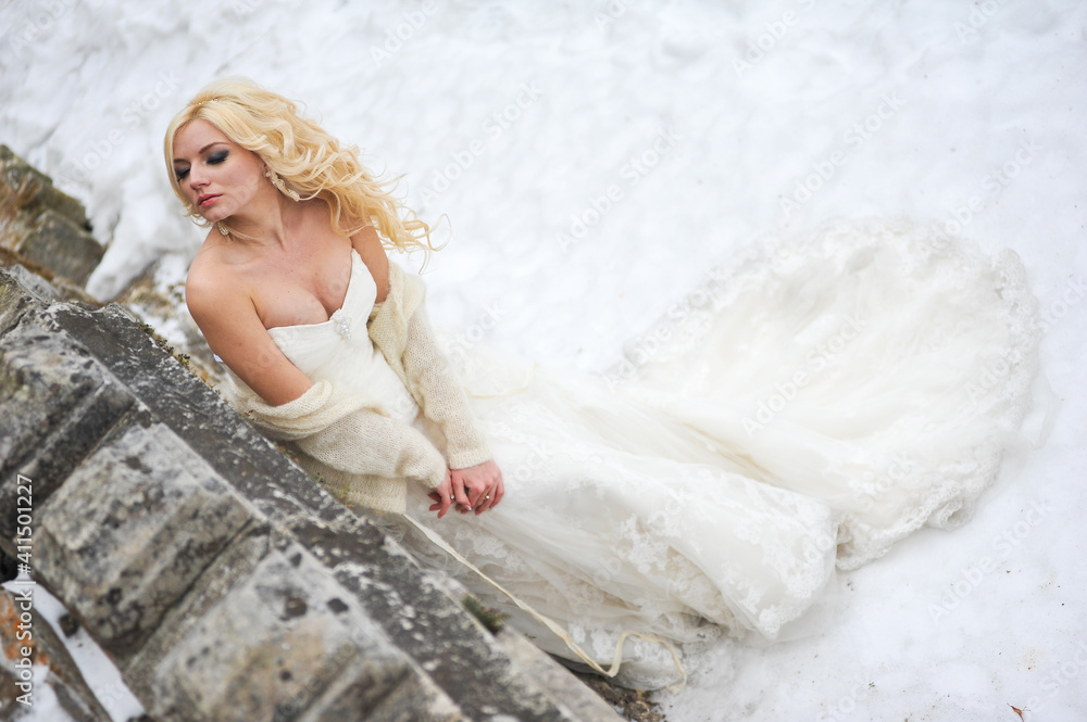 Beautiful bride near old castle on winter wedding day Beautiful bride near old castle on winter wedding day