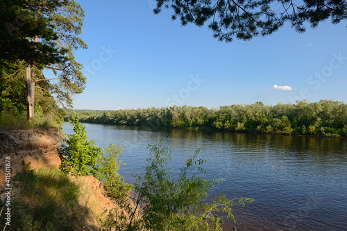 Summer landscape with a river and green banks