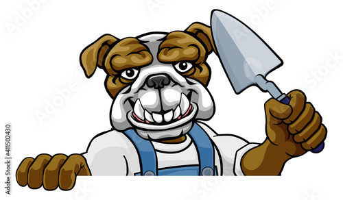 A bulldog bricklayer builder construction worker mascot cartoon character holding a trowel tool and peeking around a sign