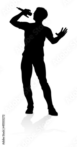 A singer pop, country music, rock star or hiphop rapper artist vocalist singing in silhouette