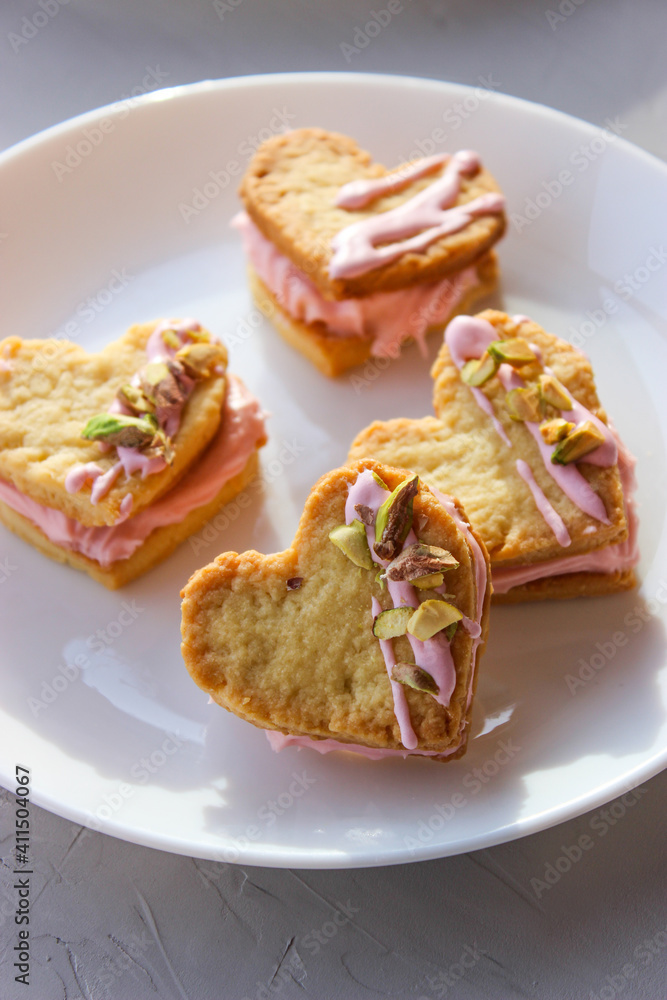 Holiday cookies in the shape of a heart, with cottage cheese cream and pistachios Holiday cookies in the shape of a heart, with cottage cheese cream and pistachios
