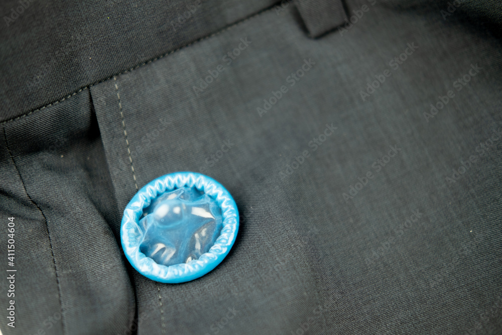 Blue condom on slack pants background Blue condom on slack pants background