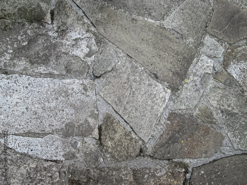 Stones of various shapes in concrete.