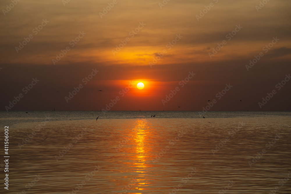 silhouette landscape sunset at the sea colorful scenic heavens orange sky outdoor nature background with bird are flying. silhouette landscape sunset at the sea colorful scenic heavens orange sky outdoor nature background with bird are flying.
