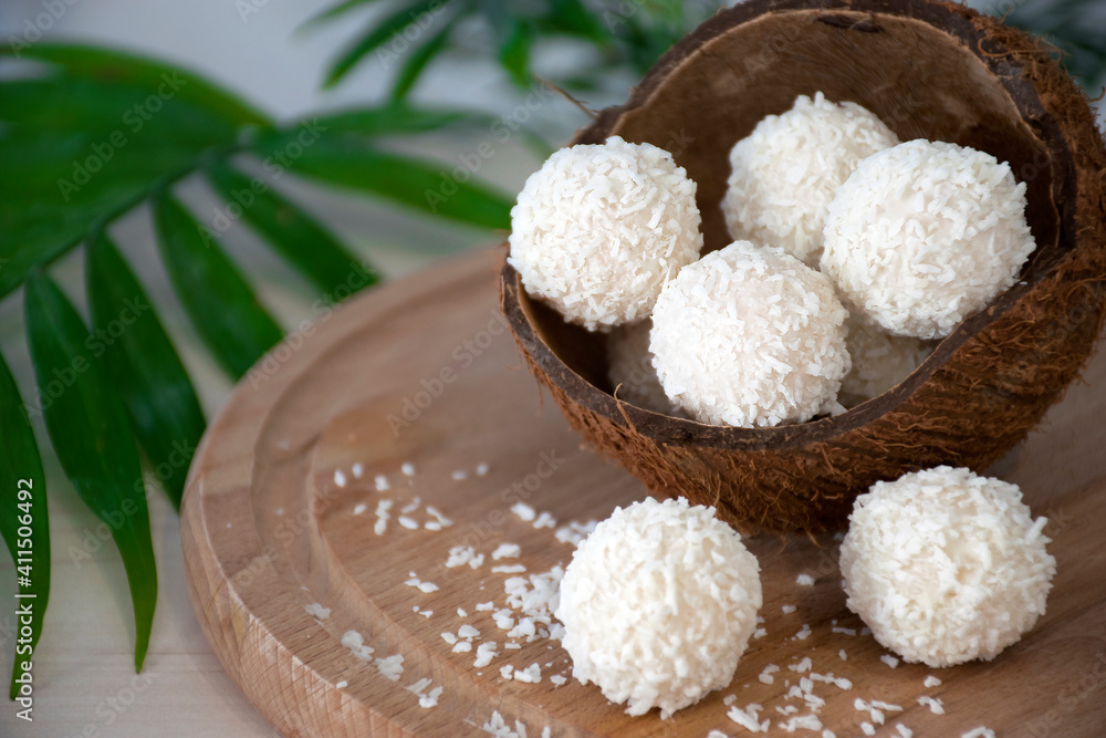 Homemade white chocolate candies in coconut flakes in nut shell on ...