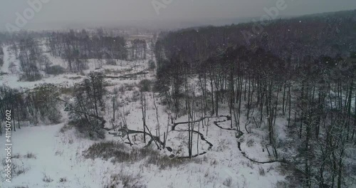 Flying along a wintert small forest river photo