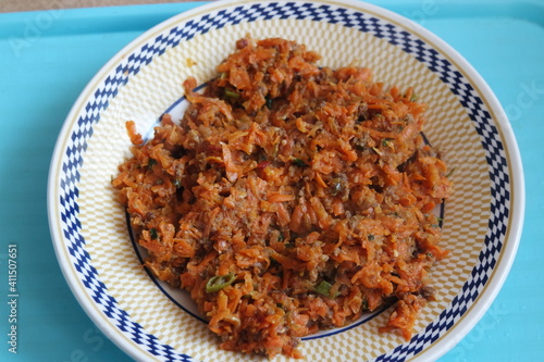Top closeup view of a homemade dish made from carrot and vegetables. photo