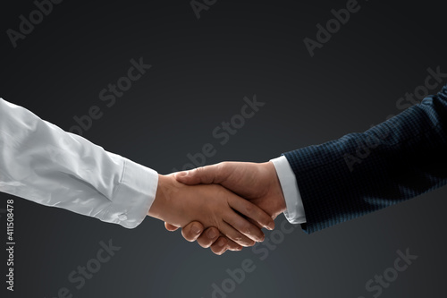 Handshake with effect, teamwork, partnership concept, business communication. Close-up.