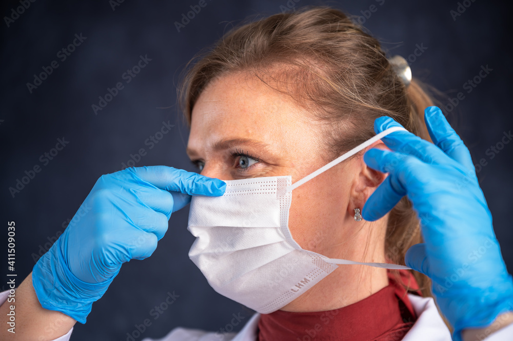 female doctor putting mask on