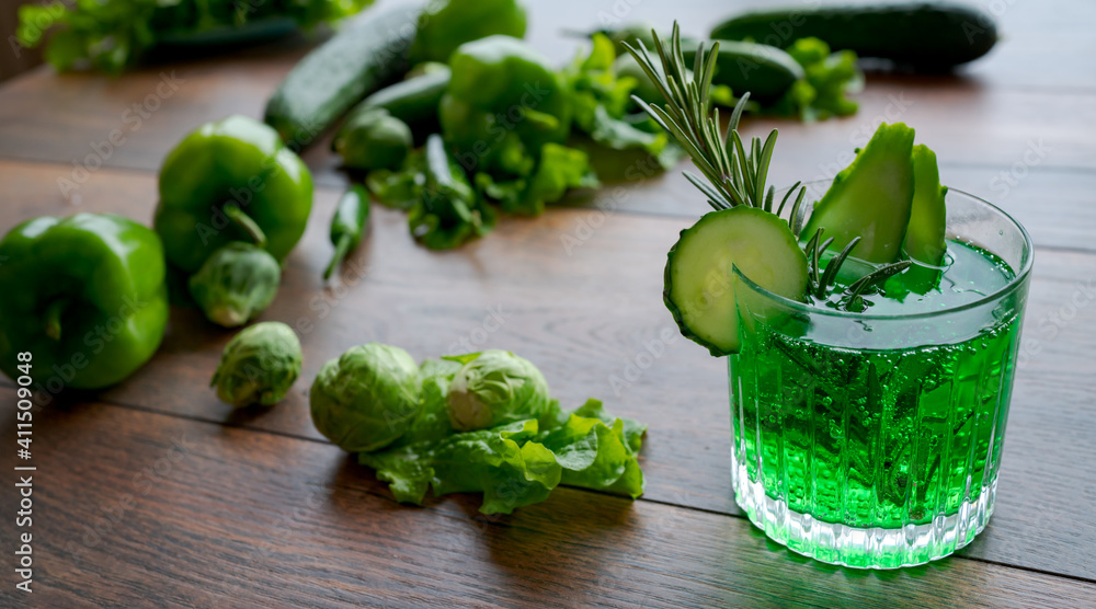Green lemonade with cucumber and rosemary on wooden table. Green lemonade with cucumber and rosemary on wooden table.