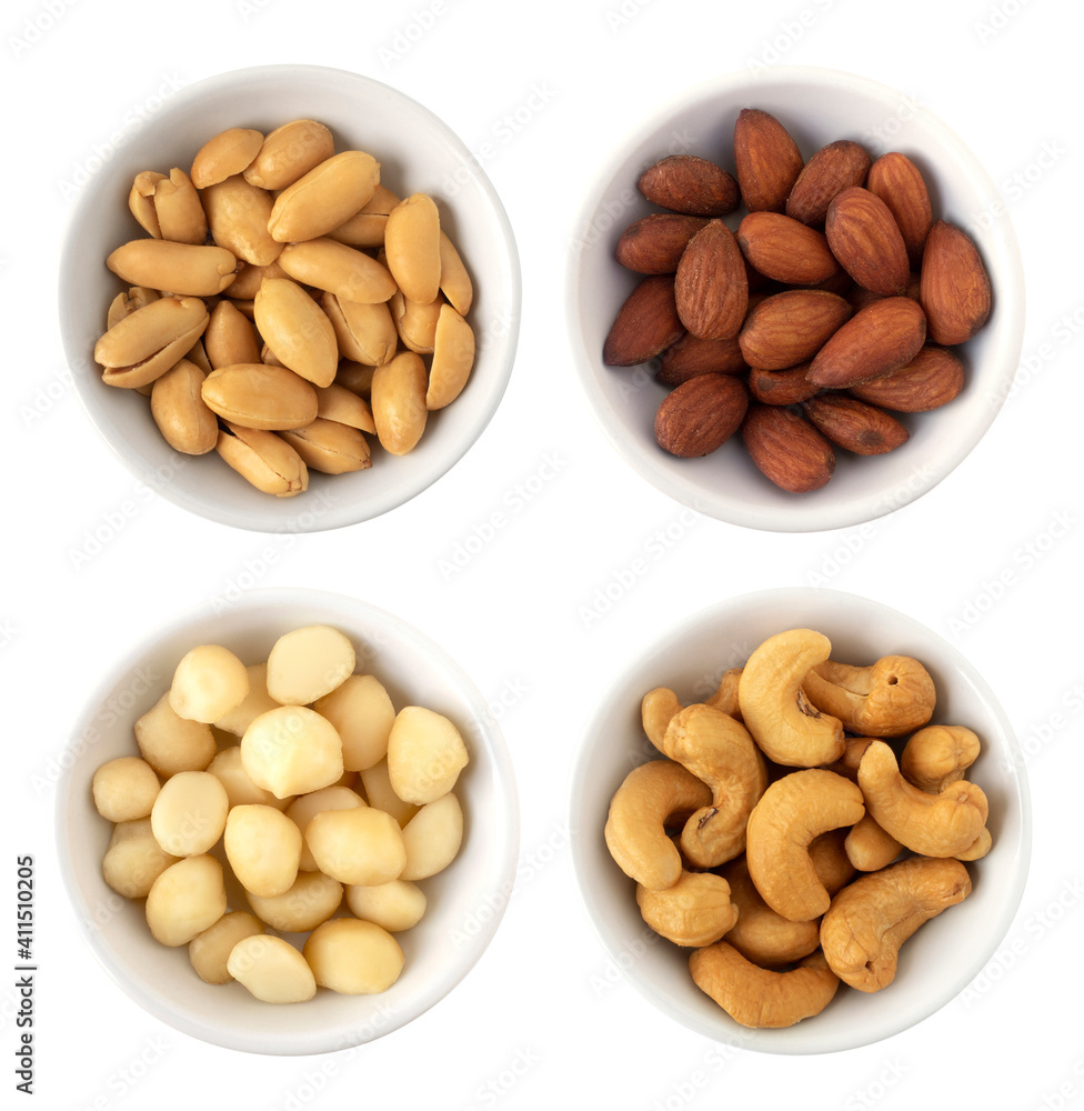 Nuts in circle shaped ceramic bowls isolated on white background. Various nuts (almonds, macadamia, cashew, peanuts). Mix nut healthy ingredients food. Nuts in circle shaped ceramic bowls isolated on white background. Various nuts (almonds, macadamia, cashew, peanuts). Mix nut healthy ingredients food.