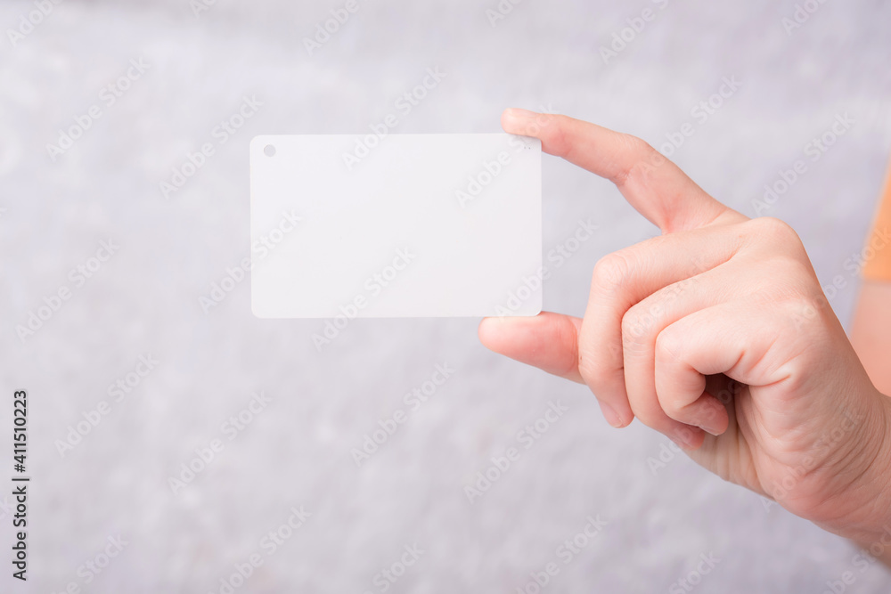 Obraz premium Credit card in female hand on white background