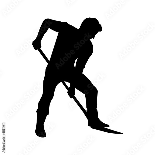 Silhouette of a man with a shovel digs soil. Farmer or gardener planting in the garden or