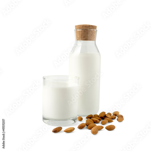 Organic almonds milk in glass and glass bottle with heap almond nuts isolated on white background for almond milk can improve health concept.