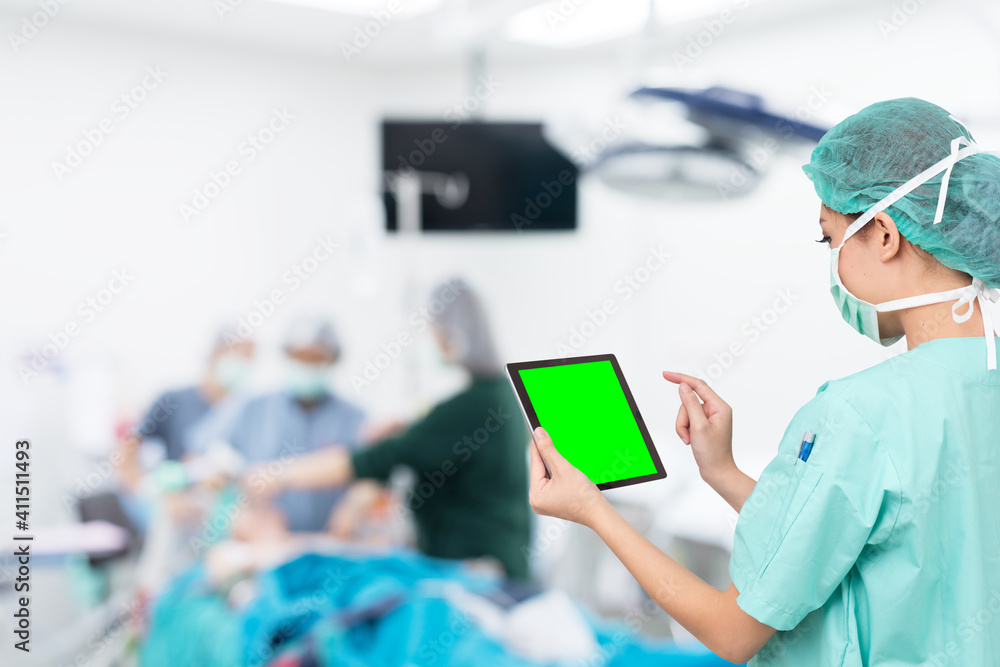 asian woman doctor use digital tablet in operating room asian woman doctor use digital tablet in operating room