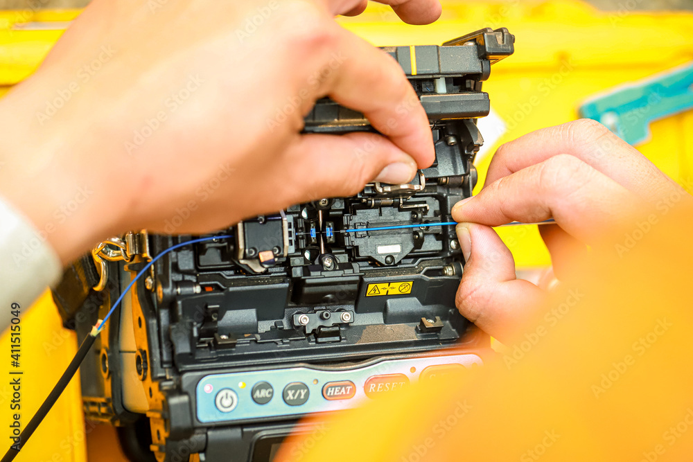 Fiber Optic Fusion Splicing Cable checking signal and Wire connection with Fiber Optic Fusion Splicing machine.The technician is checking the fiber optic cable Fiber Optic Fusion Splicing Cable checking signal and Wire connection with Fiber Optic Fusion Splicing machine.The technician is checking the fiber optic cable