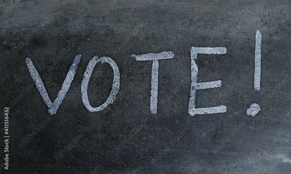 Fototapeta premium Vote Word Written on Blackboard with Exclamation Mark
