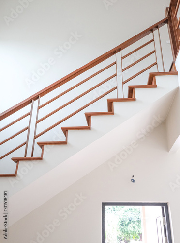 abstract start to goal up to stair. wooden in new house structure use lightweight cement brick and white lintel plaster to joint for reinforce in site. oak color iron Handrail decor interior estate.